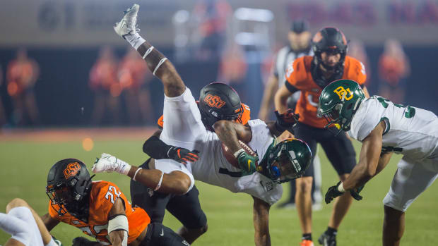Oct 2, 2021; Stillwater, Oklahoma, USA; Oklahoma State Cowboys linebacker Kamryn Farrar (44) tackles Baylor Bears running back Trestan Ebner (1) during the fourth quarter at Boone Pickens Stadium. Mandatory Credit: Brett Rojo-USA TODAY Sports